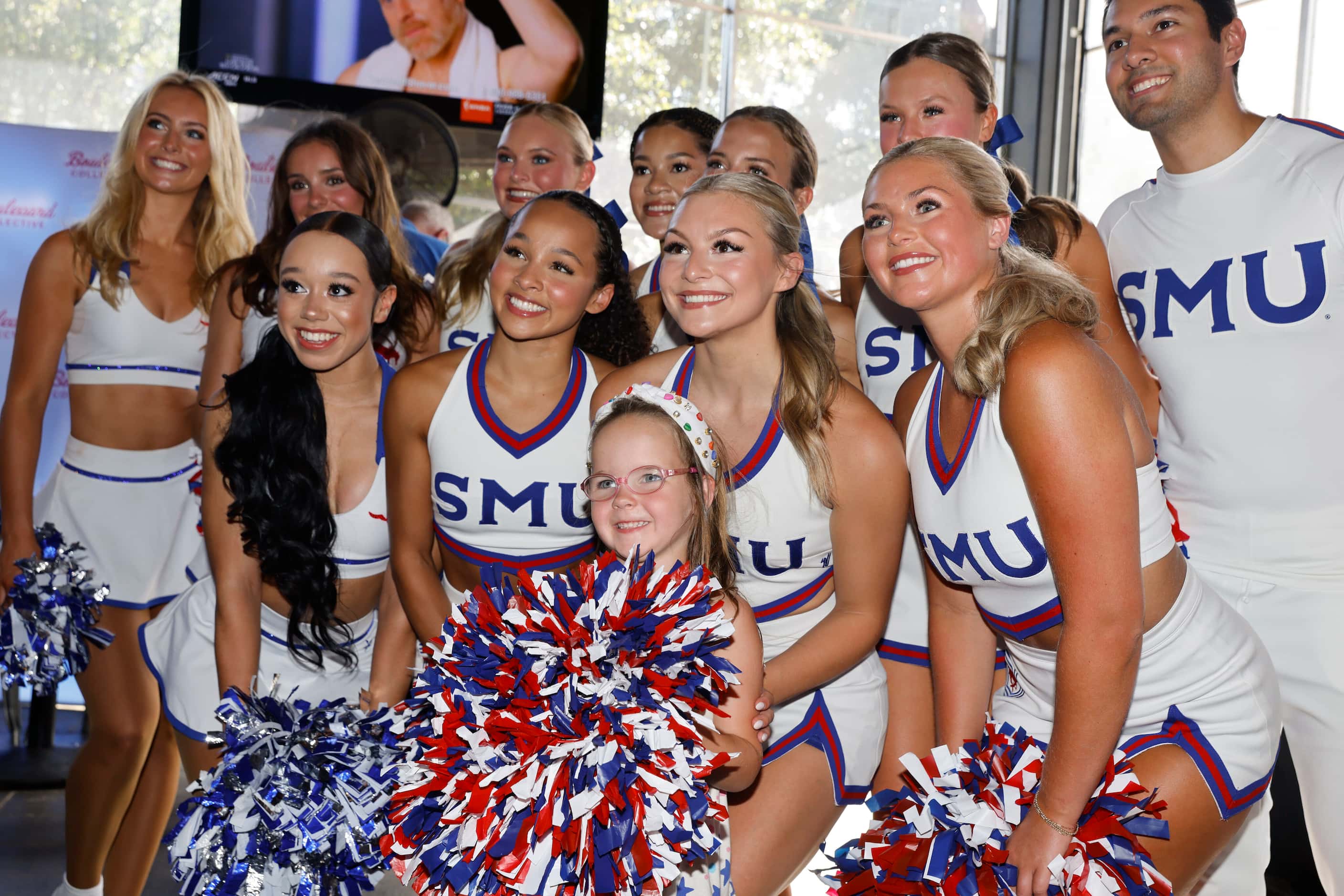 Adelaide Sherwood, 4, poses for a photo with SMU cheerleaders during a celebration of SMU’s...