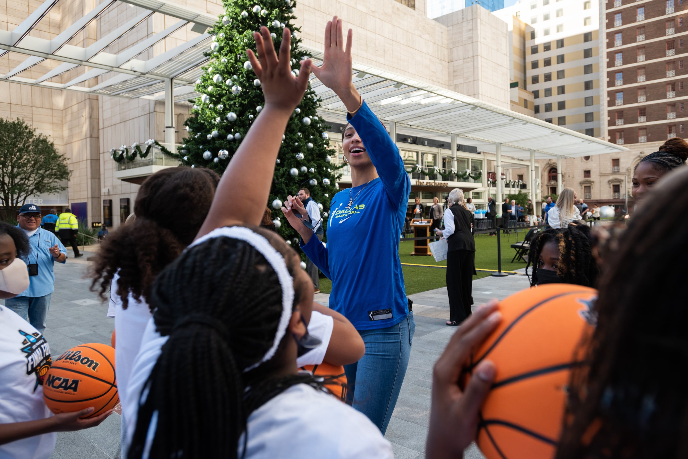 Eden Murrell, 11, left, of St. Philip's School and Community Center, receives a high-five...