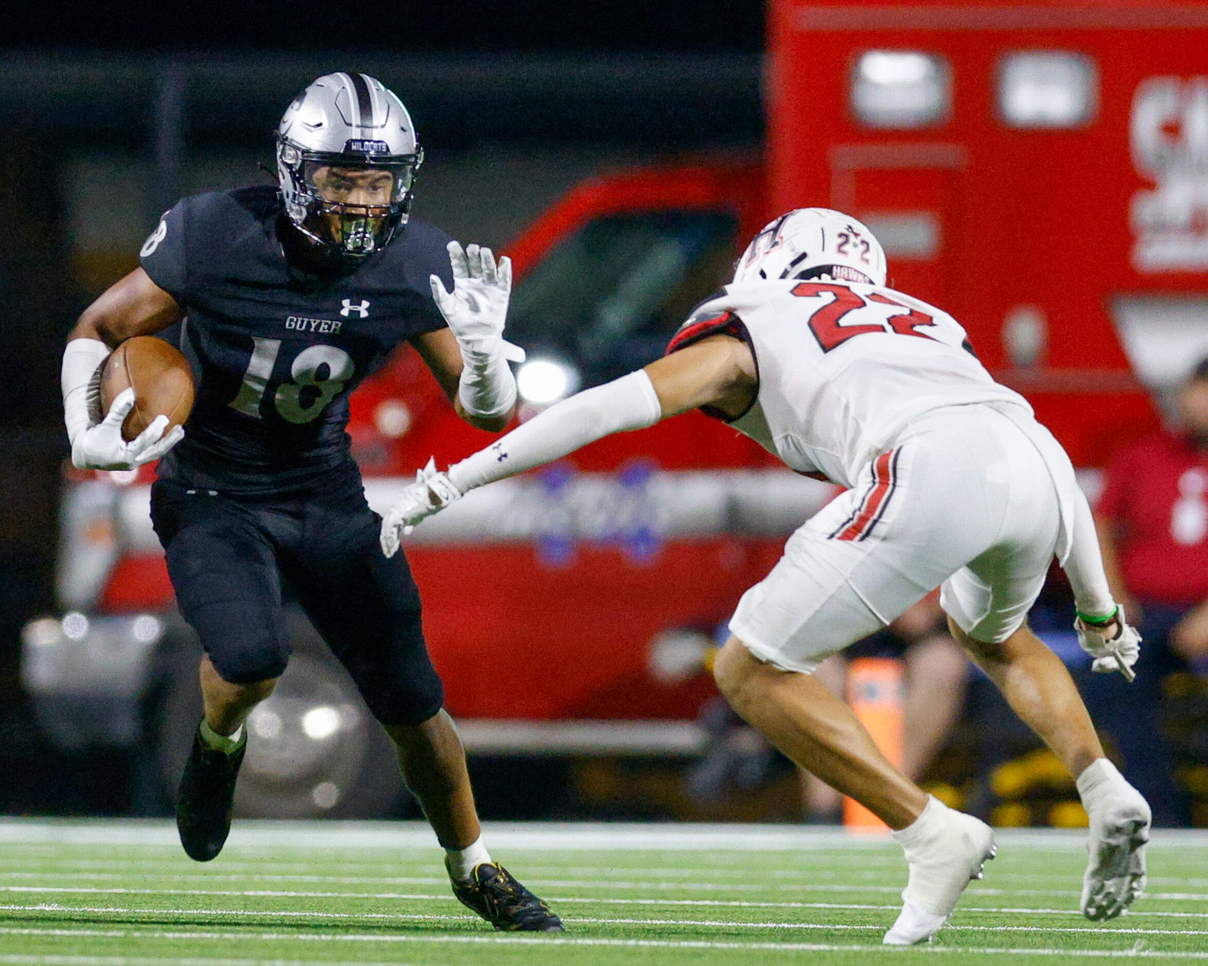 Rockwall-Heath defensive back Patrick Donaldson (22) tackles Denton Guyer wide receiver Eli...