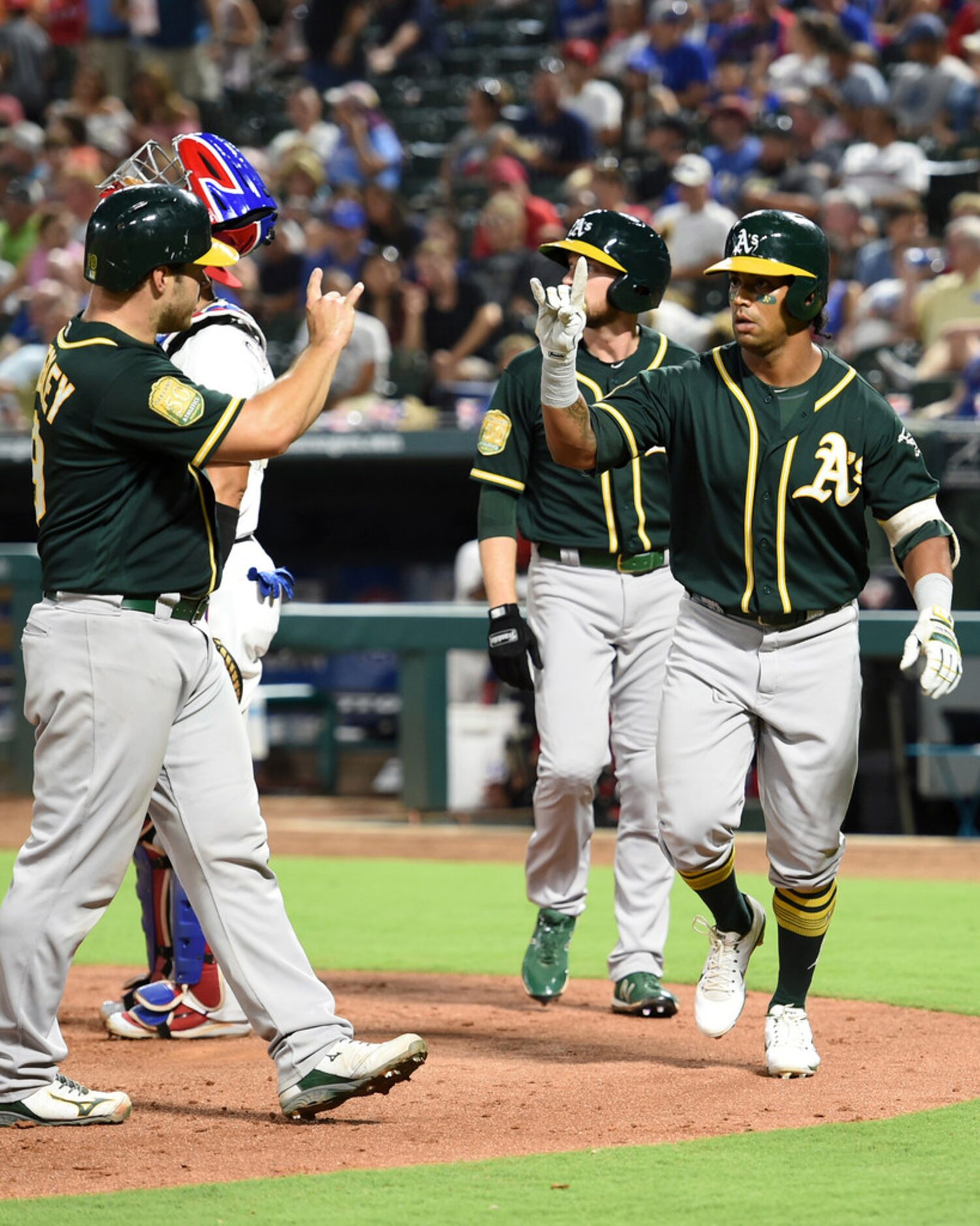 Oakland Athletics' Khris Davis, right, celebrates with teammate Josh Phegley, left, after...