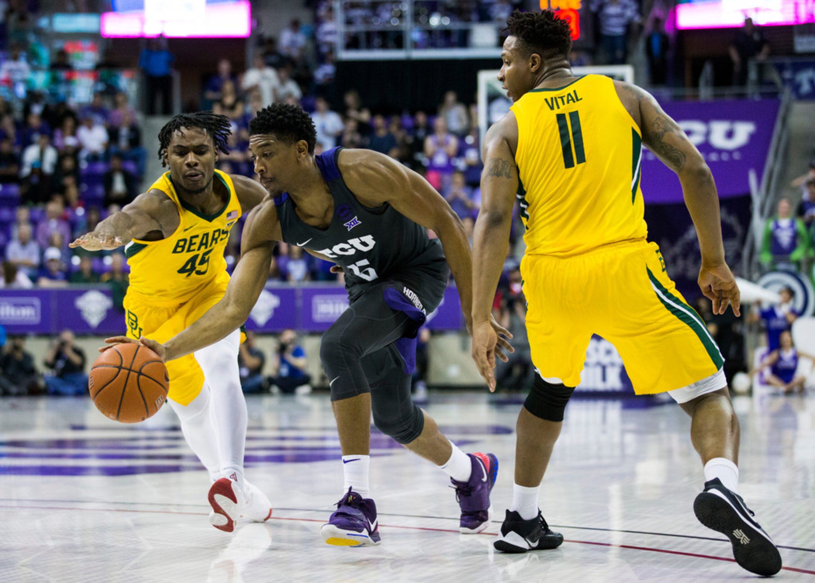 TCU Horned Frogs guard Jaire Grayer (5) finds a hole between Baylor Bears guard Davion...