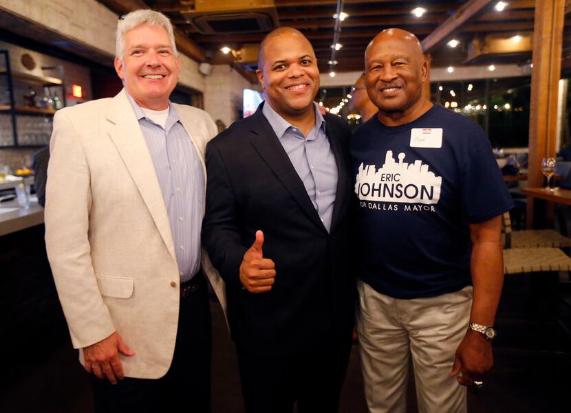 Dallas mayoral candidate and current State Representative Eric Johnson (center) poses for a...