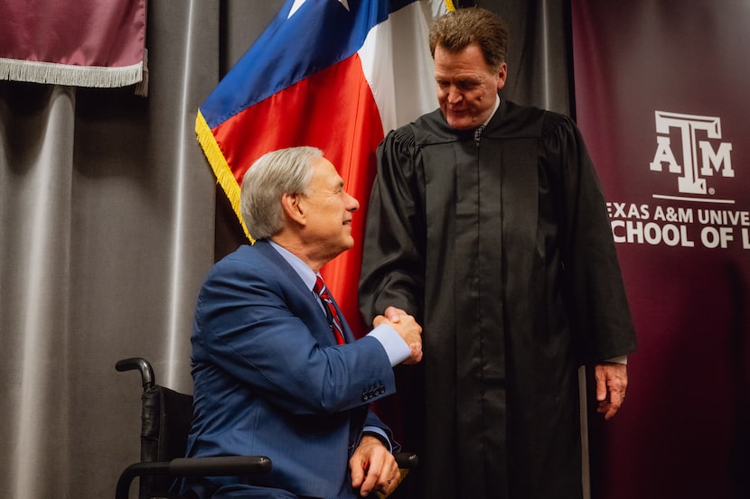 Texas Governor Greg Abbott shakes hands with Jerry Bullard, newly appointed Eighth Business...