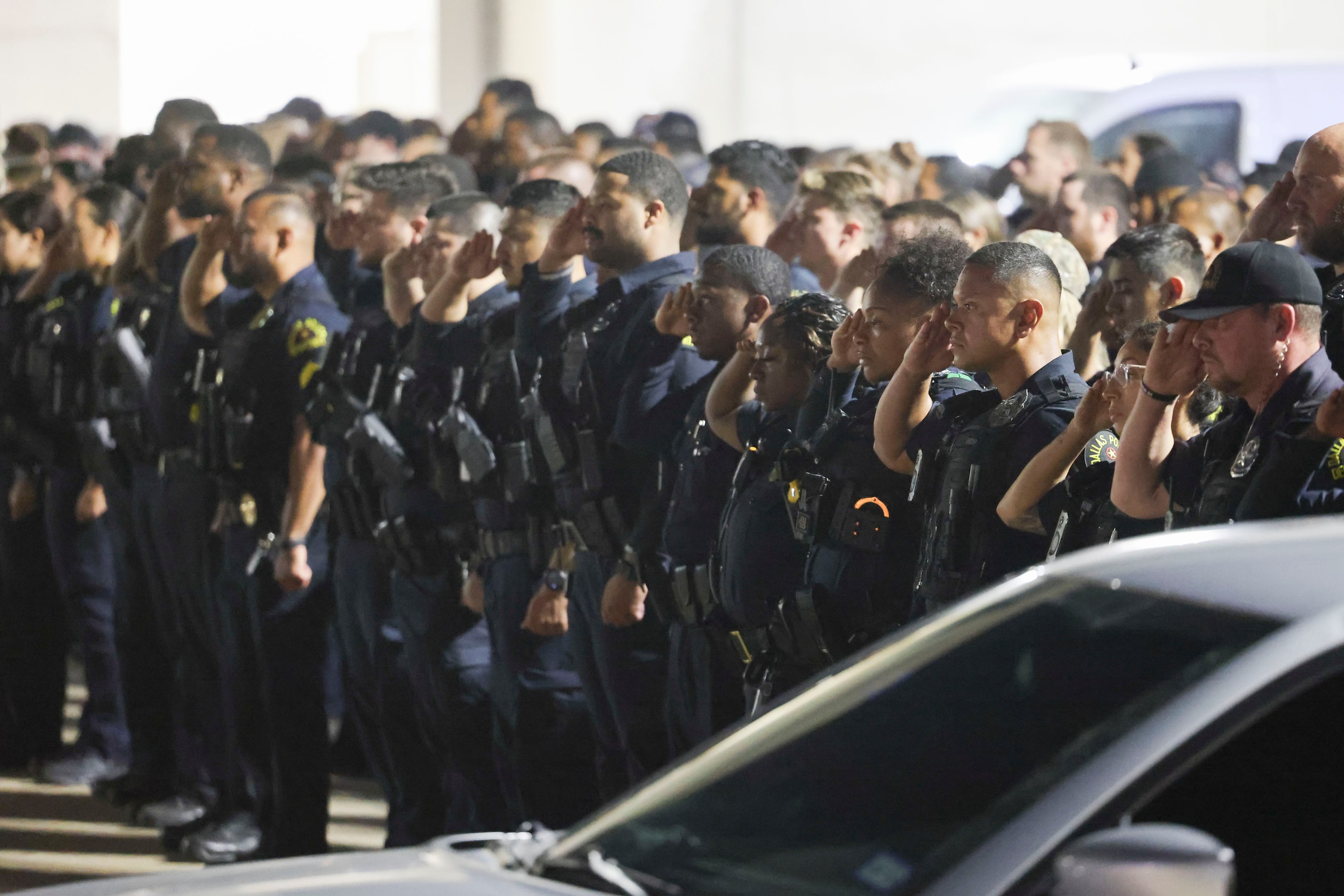 Dallas Police Department officers lead a guard of honor outside of Dallas County Medical...