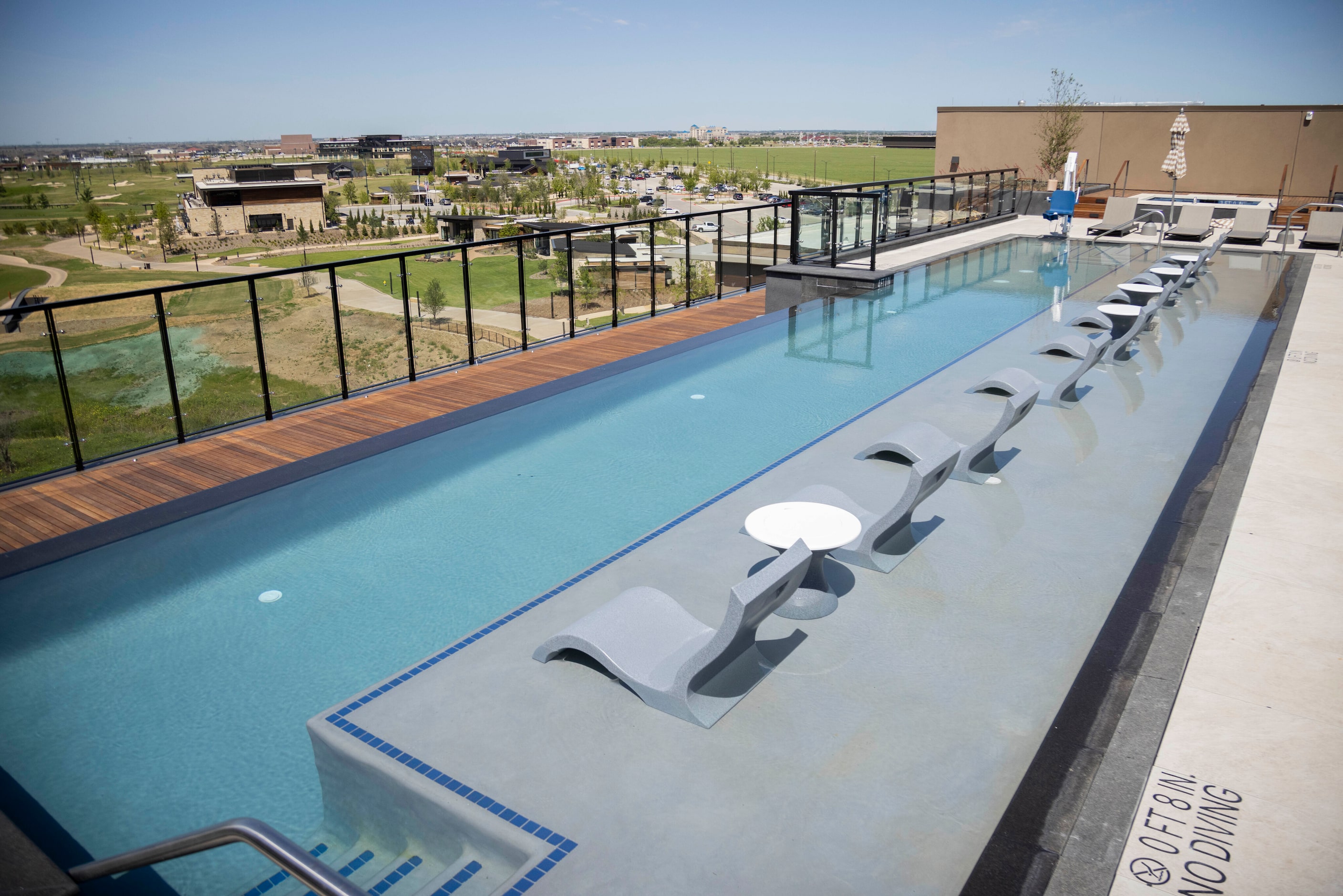 The Omni PGA Frisco Resort’s Bluestern Pool and Bar overlooks the Fields Ranch golf courses...