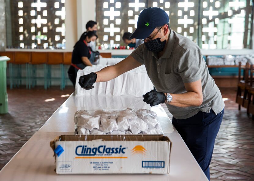 José restaurant general manager Victor Rojas wraps a tray of taco meals to be delivered to...