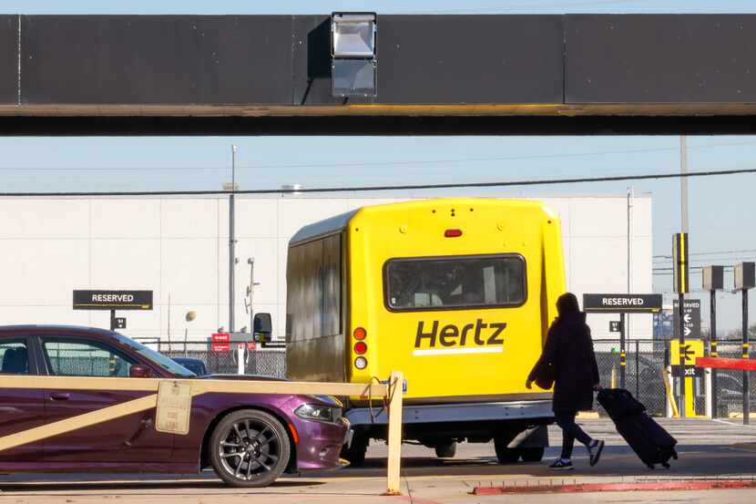 A traveler moved to the car pickup of a Hertz rental car office at Dallas Love Field Airport...