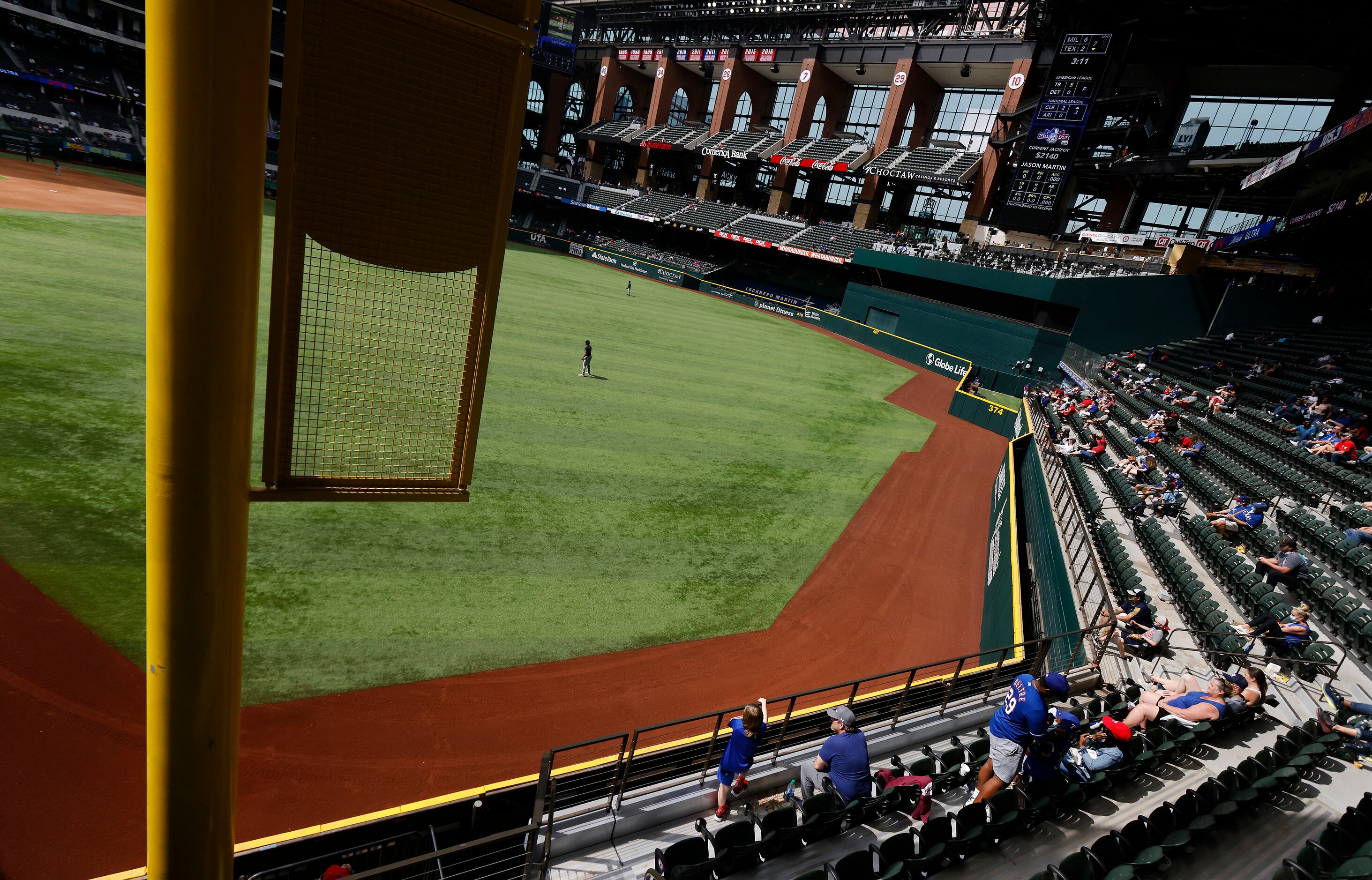 Texas Rangers fans in right field take in an afternoon exhibition baseball game at Globe...