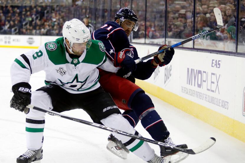 Columbus Blue Jackets forward Nick Foligno, right, becomes entangled with Dallas Stars...