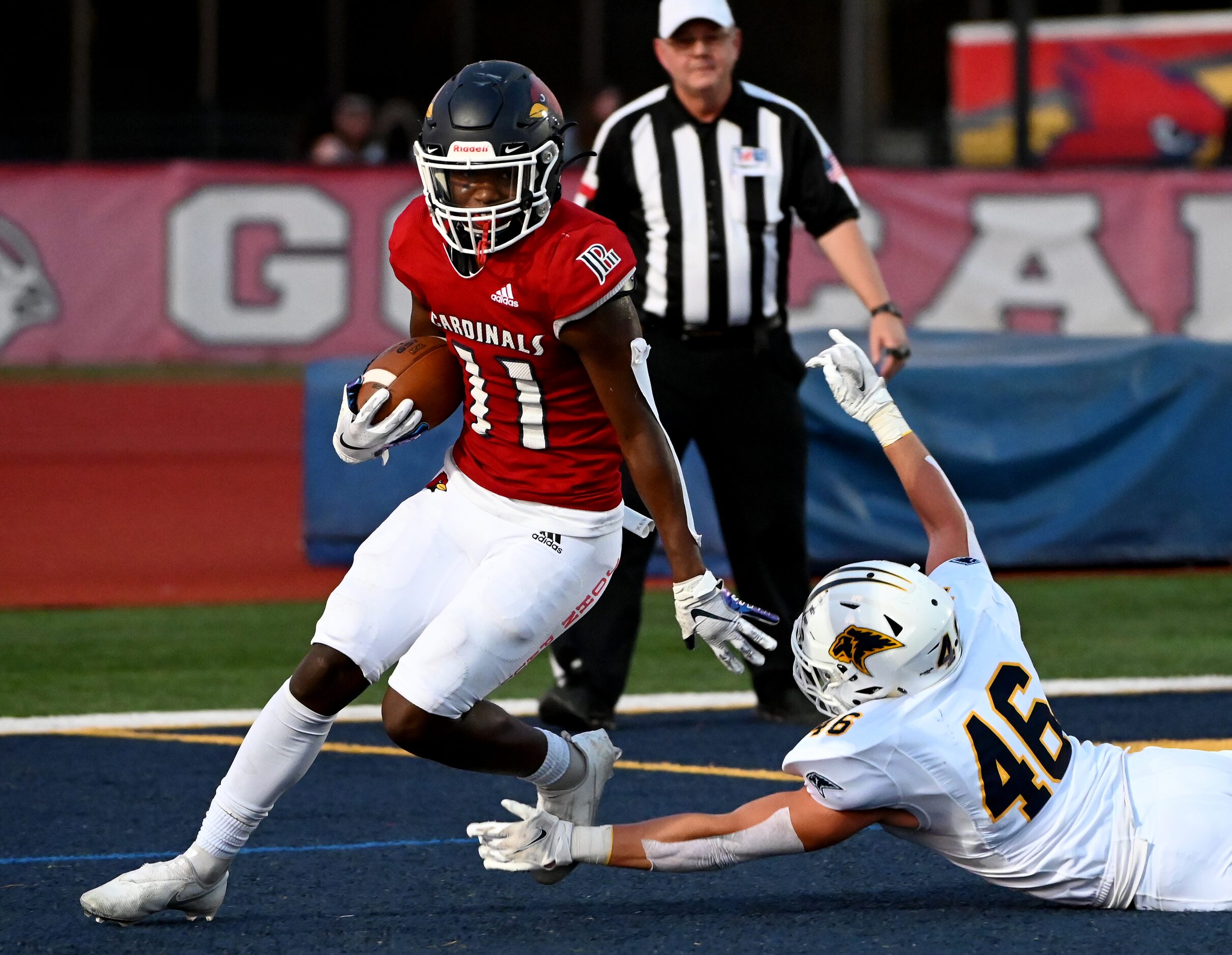 John Paul II's Caesar Alex (11) runs through tackle attempt by Prestonwood's Hudson Lunsford...