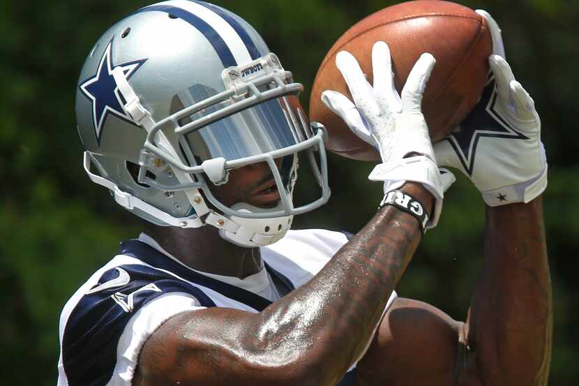 Dallas wide receiver Dez Bryant (88) works on catching passes during the first day of Dallas...