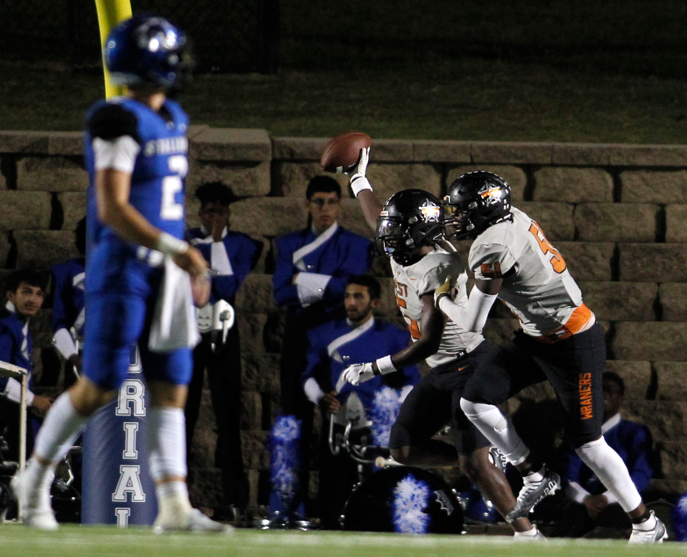 West Mesquite's Zykeus Castle (5), center, celebrates with teammate JD Cotton (51), right,...