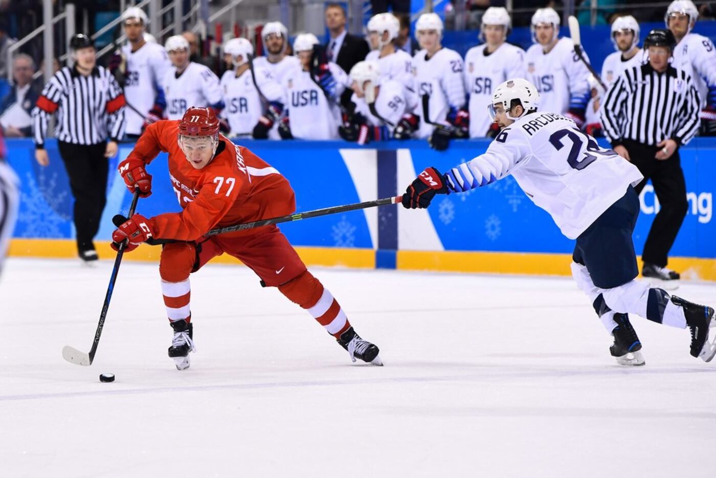 Russia's Kirill Kaprizov and USA's Mark Arcobello vie for the puck in the men's ice hockey...