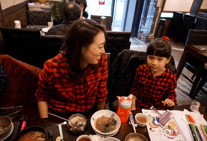 Elise Hu, NPR reporter, eats dinner with her daughter, Eva, 5.