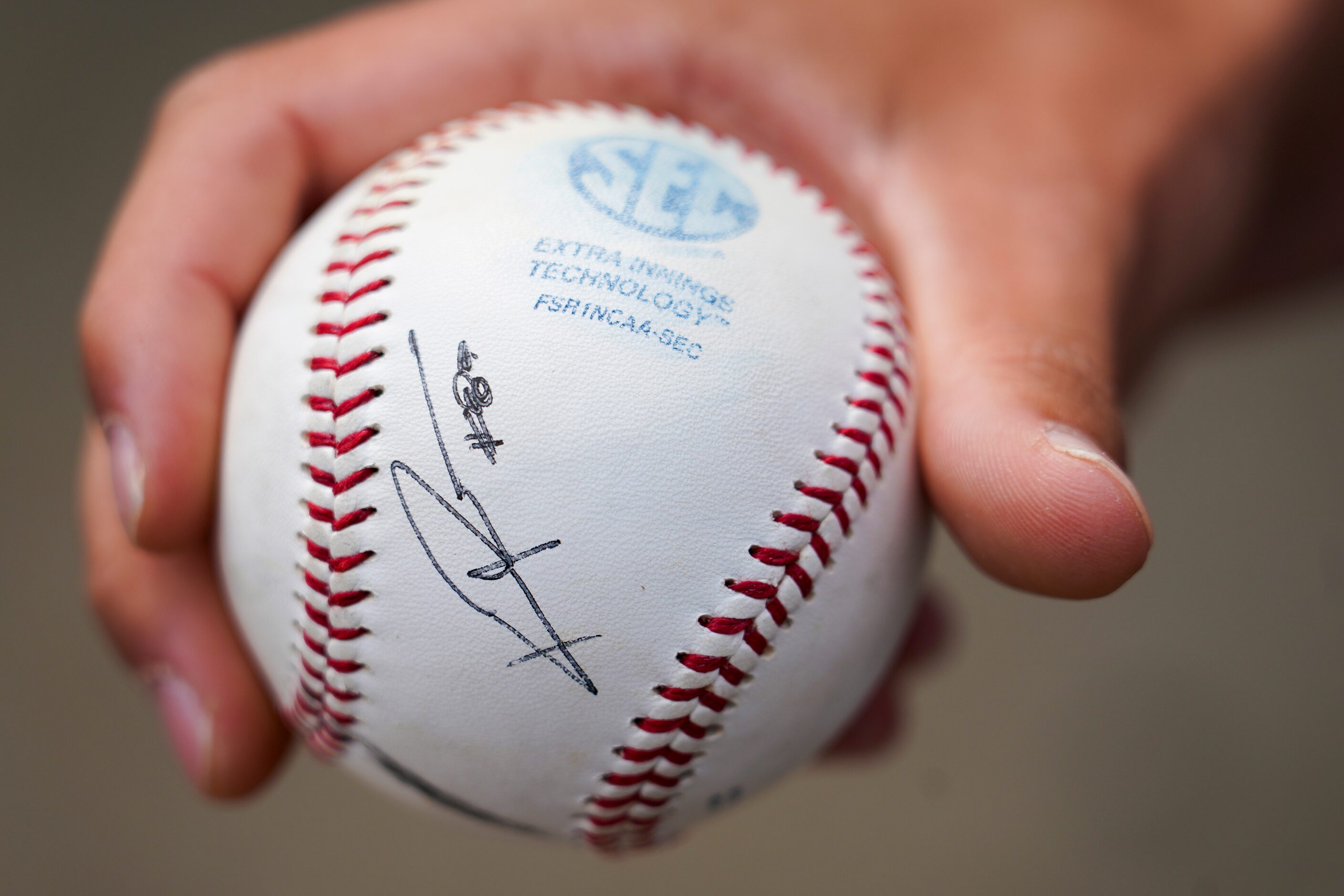 A fan shows of a ball he had autographed by Vanderbilt pitcher Kumar Rocker before an NCAA...