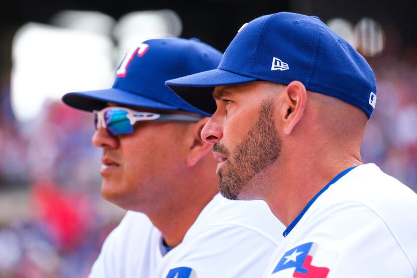 Texas Rangers manager Chris Woodward (right) and pitching coach Julio Rangel watch from the...
