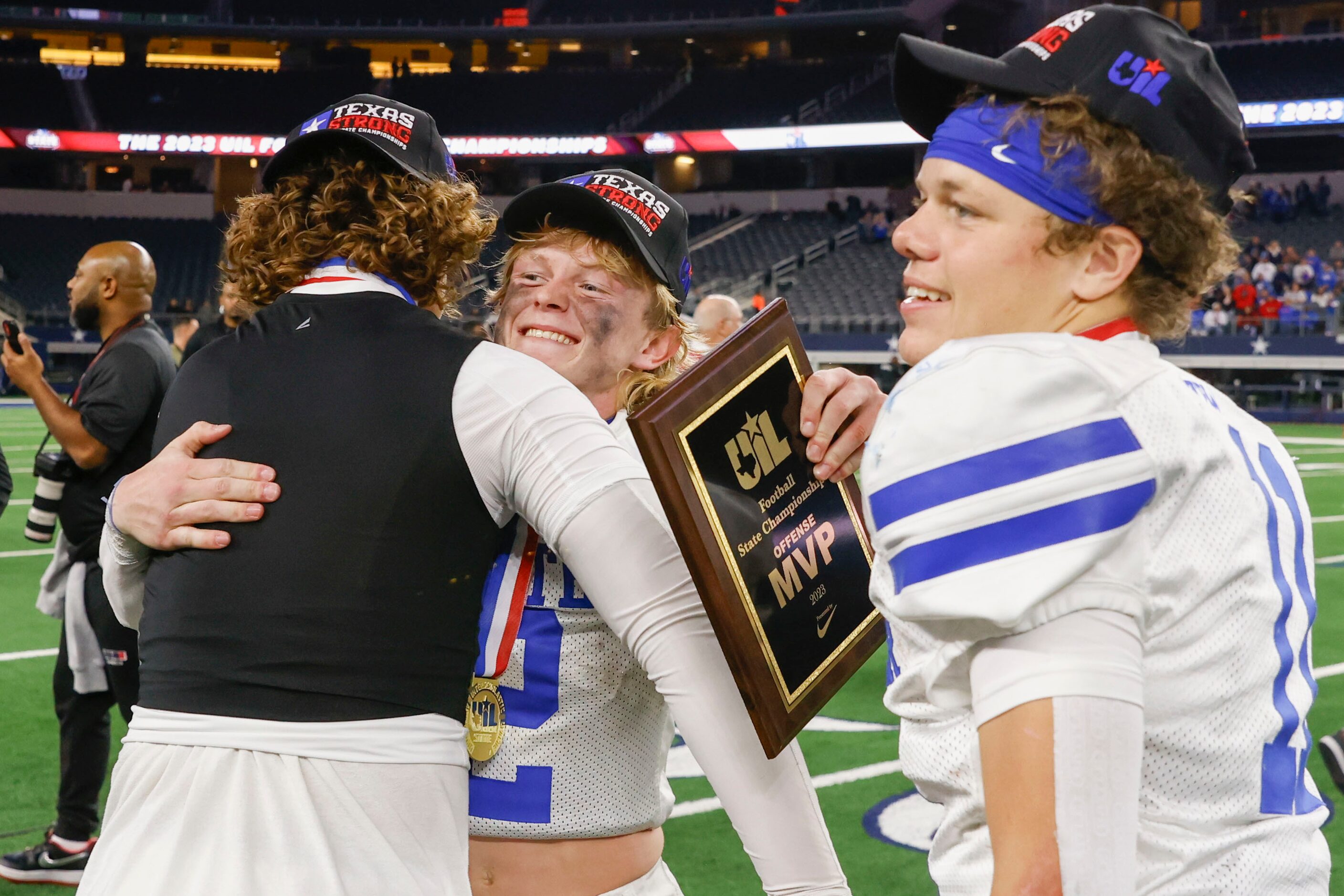 Gunter High’s QB Walker Overman (center) celebrate as he becomes the MVP after winning the...