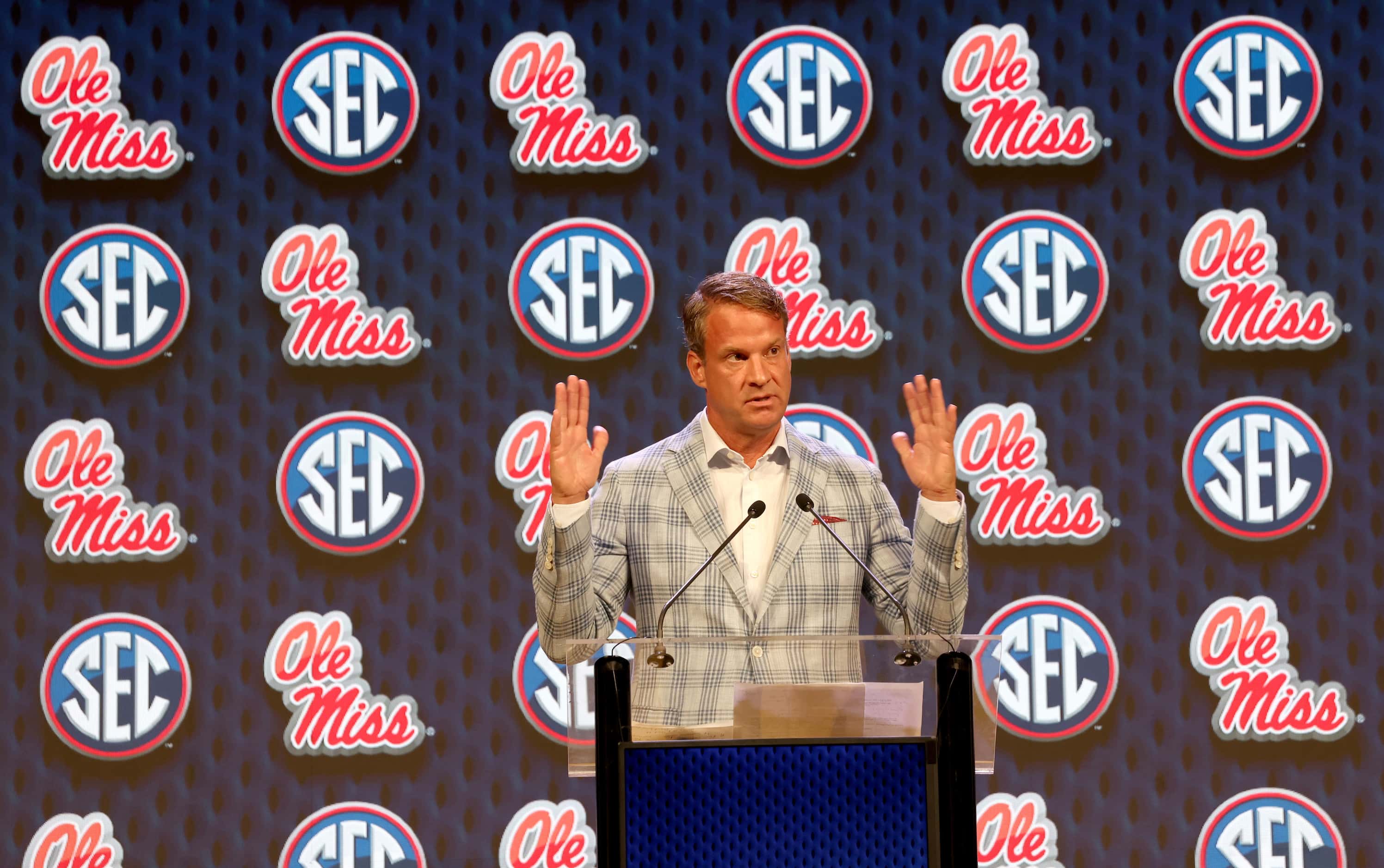 Lane Kiffin, head football coach at Ole Miss, answers the question of a media member. The...