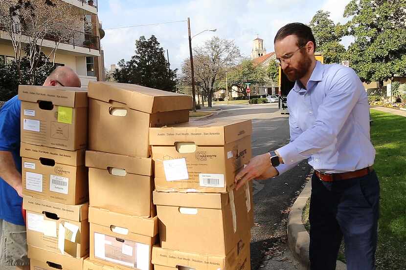 Dallas Catholic Diocese Chancellor Greg Caridi accepts boxes of documents that police had...