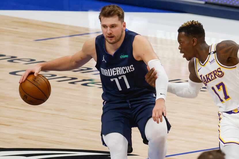 Dallas Mavericks guard Luka Doncic (77) is guarded by Los Angeles Lakers guard Dennis...