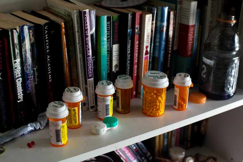 Prescription medications sit on a bookshelf at a home in Taylorsville, Utah on July 24, 2013. 