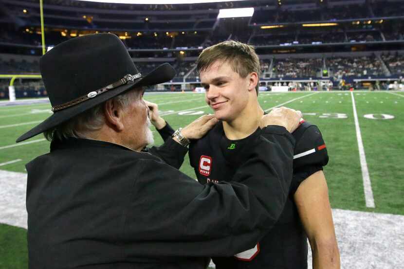 Lake Travis quarterback Charlie Brewer, right, gets a congrats from his grandfather Charlie...