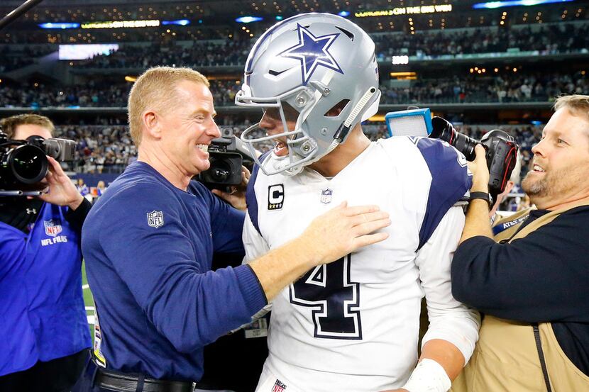 Dallas Cowboys head coach Jason Garrett congratulates quarterback Dak Prescott (4) on the...