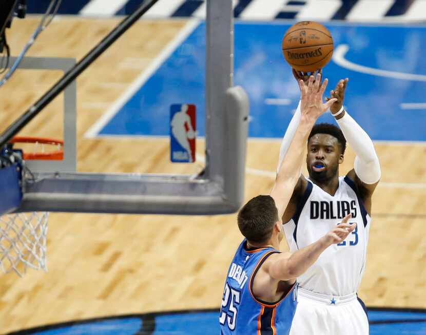 Dallas Mavericks guard Wesley Matthews (23) shoots over Oklahoma City Thunder forward Doug...