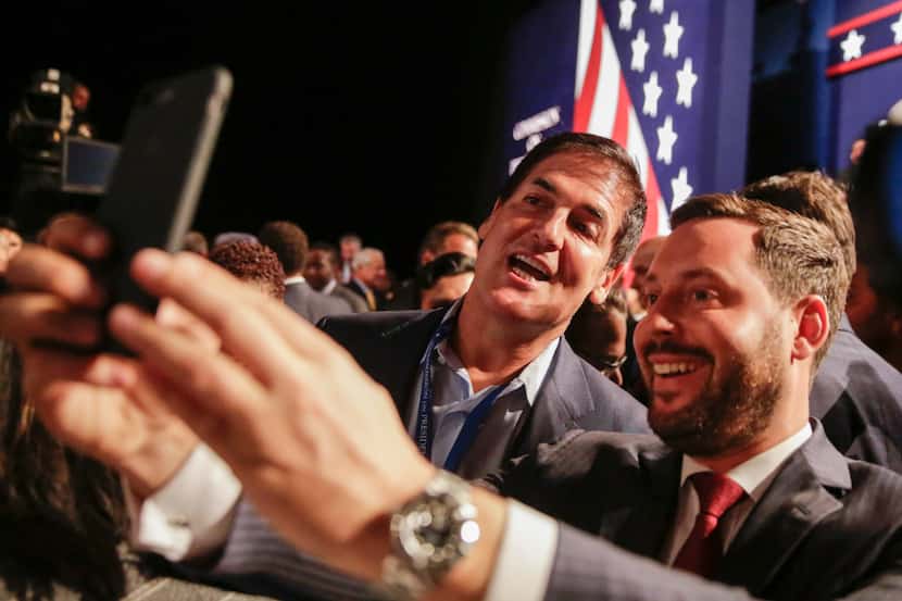 Businessman Mark Cuban and Michael Kives pose for a selfie before the presidential debate...