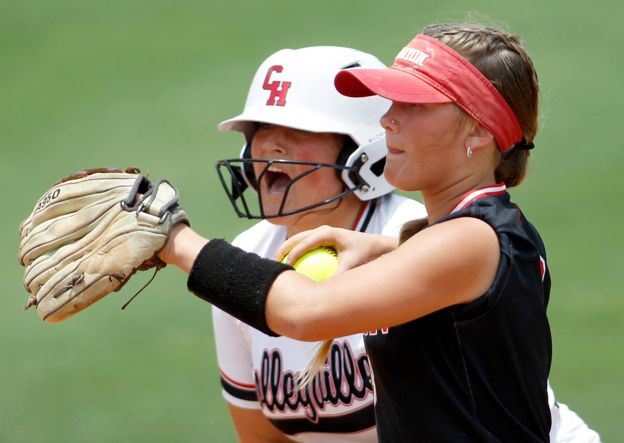 Colleyville Heritage infielder Luna Flores (10), background, lets out a yell after reaching...