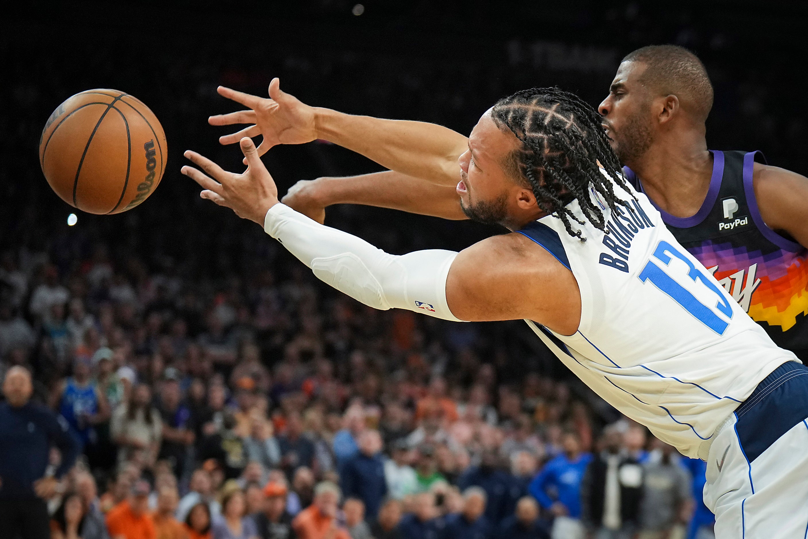 Dallas Mavericks guard Jalen Brunson (13) fights for the ball against Phoenix Suns guard...