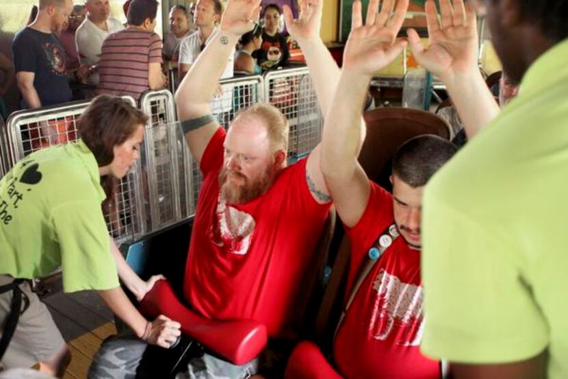 
Ride operators secured  guests on the Texas Giant at Six Flags Over Texas in Arlington last...