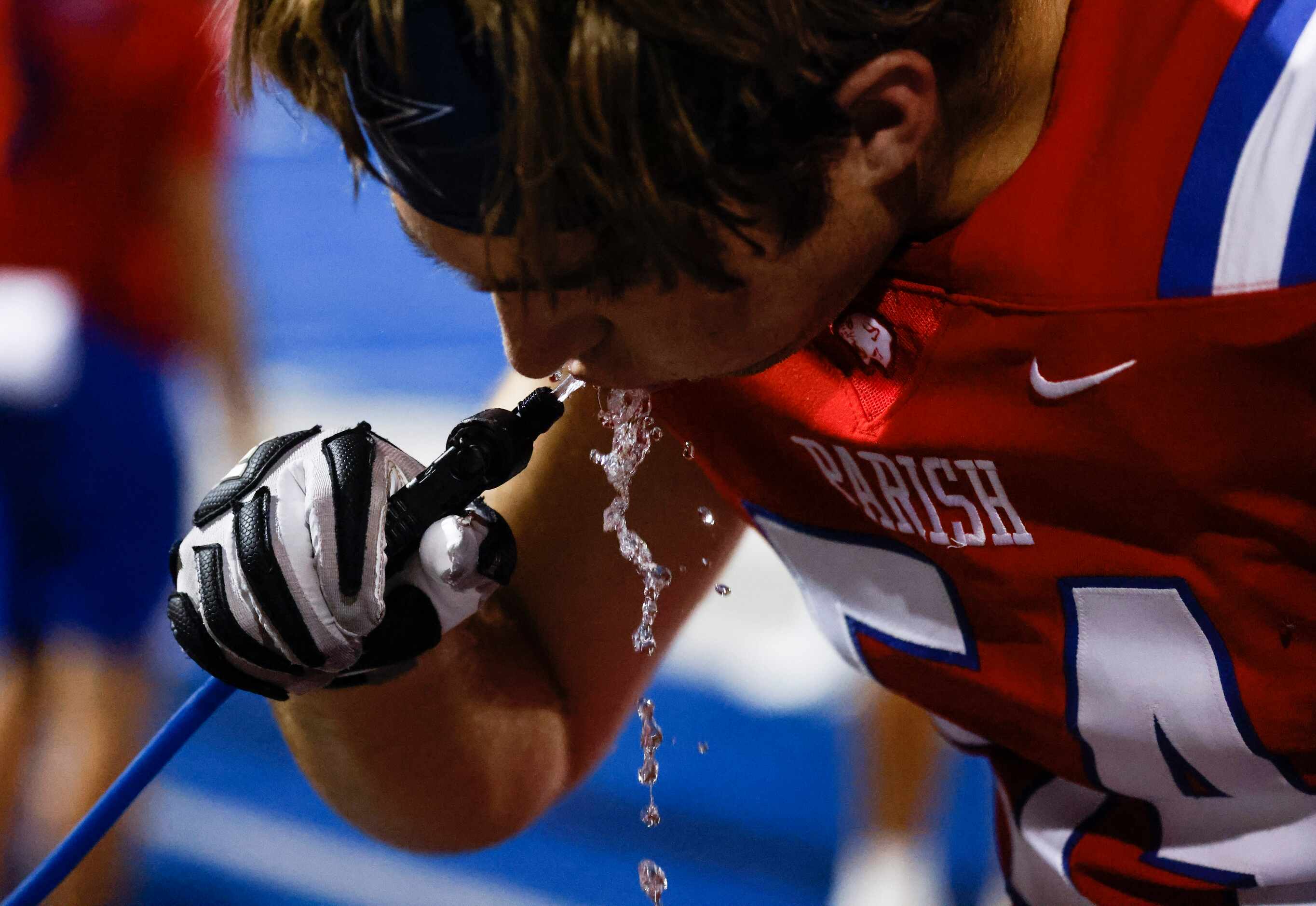 Parish Episcopal School’s Alex Jacoby (54) hydrates during the second half of a...