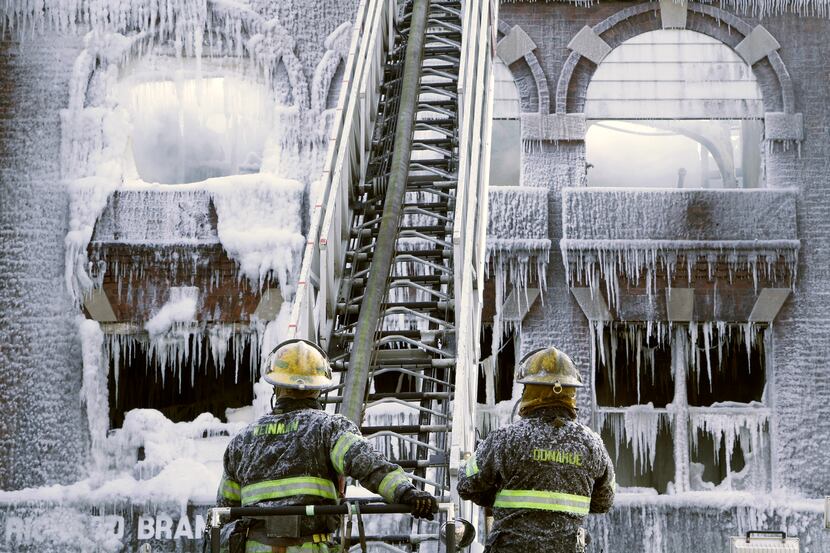 Philadelphia firefighters work the scene of an overnight blaze in west Philadelphia, Monday...