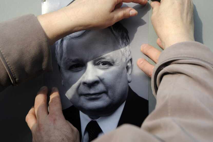 Employees of the Polish Embassy place the portrait of Polish President Lech Kaczynski near...