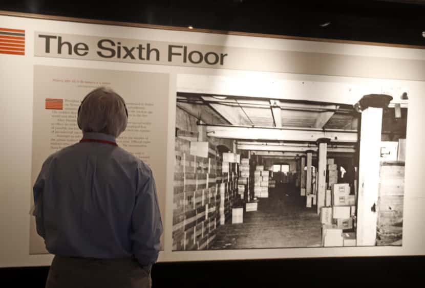 A visitor looks over displays at the Sixth Floor Museum in Dallas.