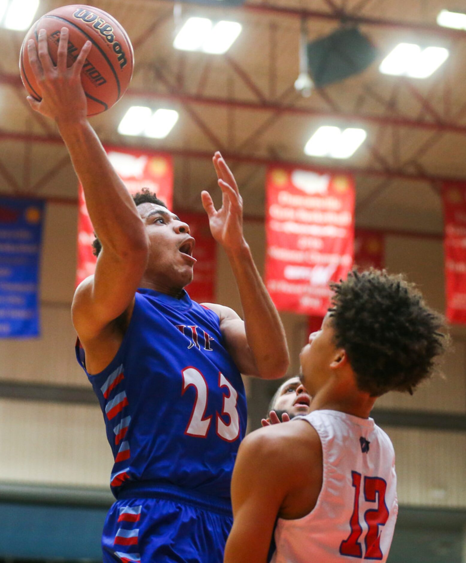 J. J. Pearce guard Sterling Hopkins (23) shoots as he is defended by Duncanville guard Miles...