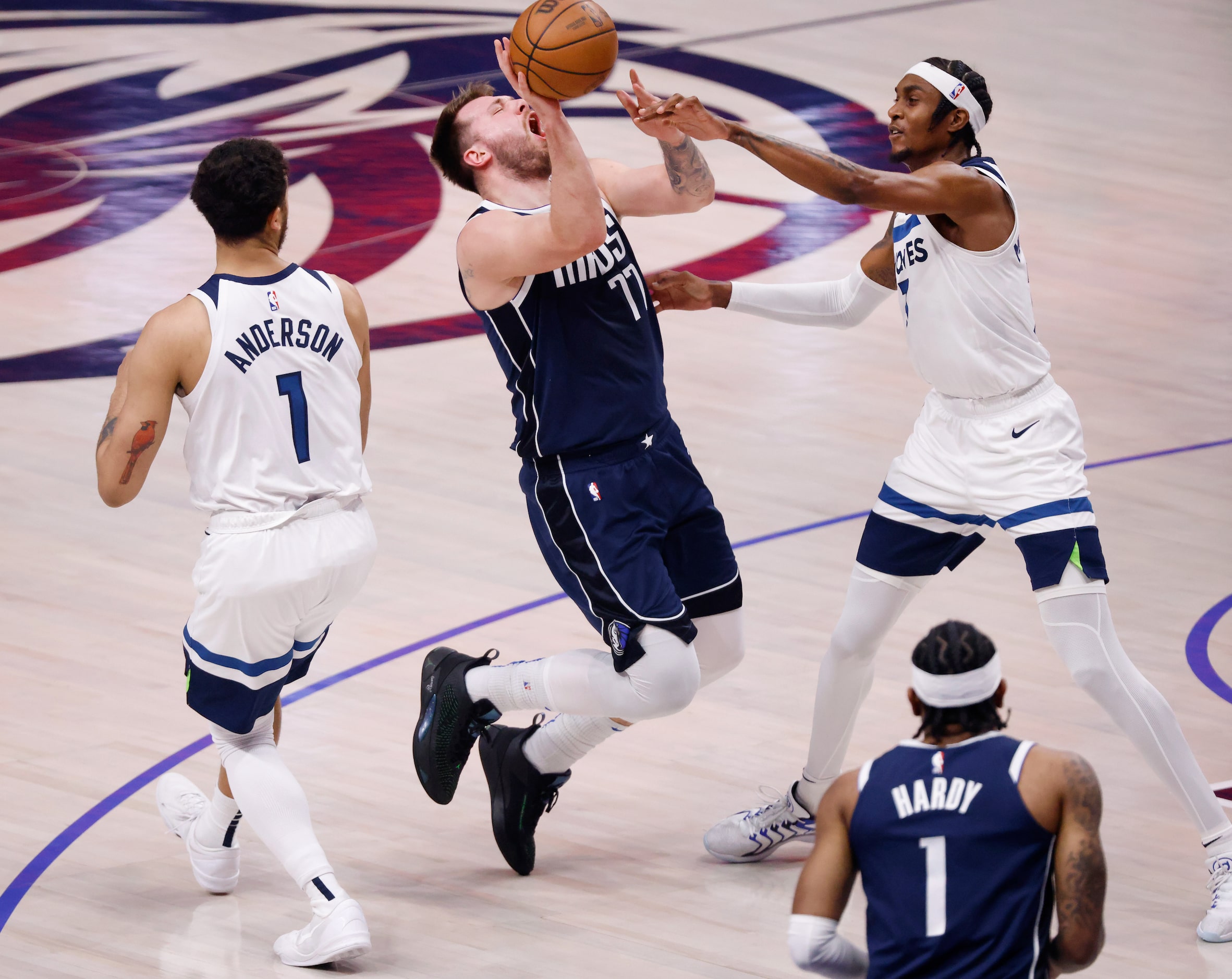 Dallas Mavericks guard Luka Doncic (77) is fouled by Minnesota Timberwolves forward Kyle...