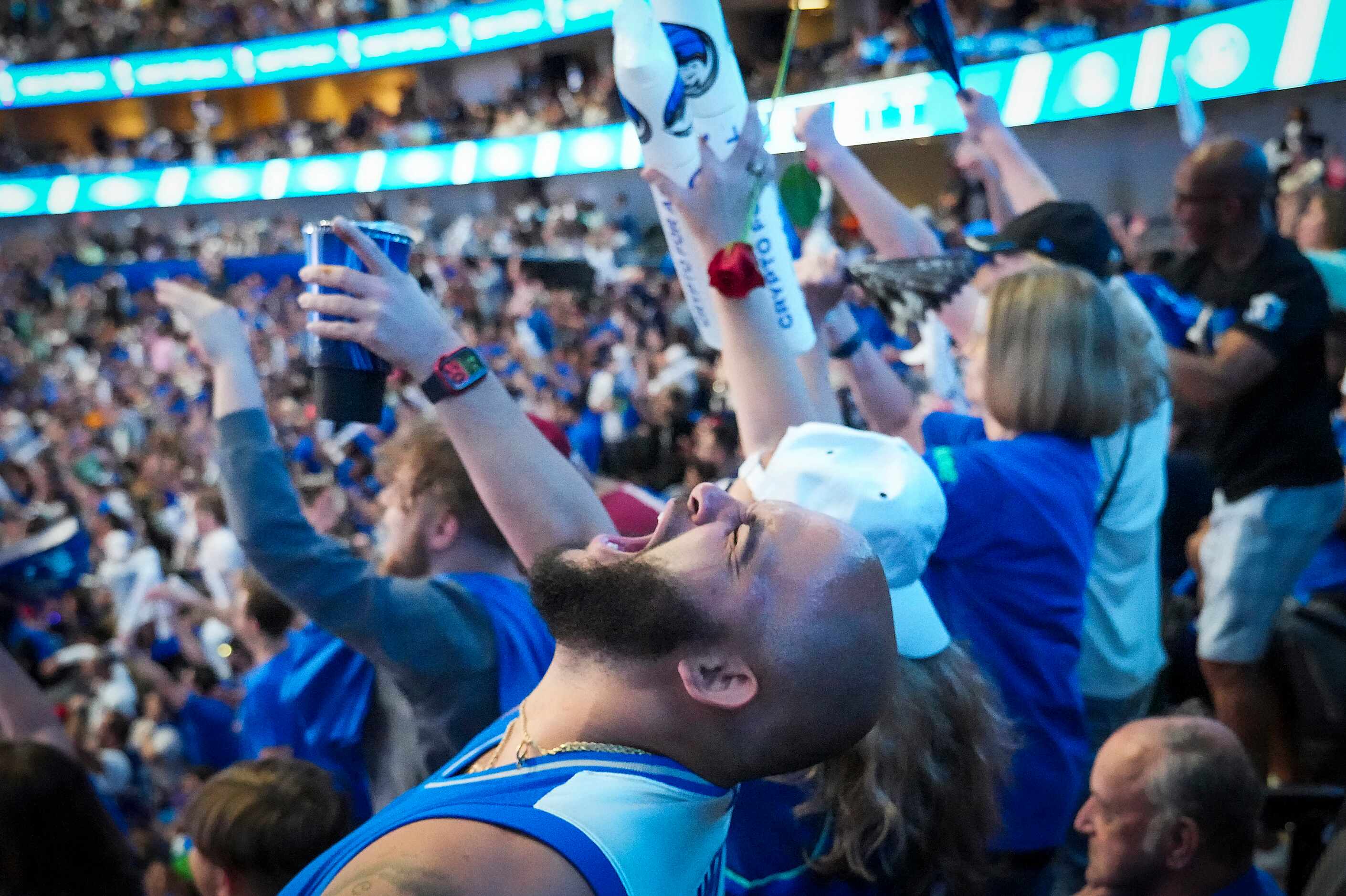 Dallas Mavericks fan D’Andre Wilson of Texarkana lets out a yell as fans celebrate a...