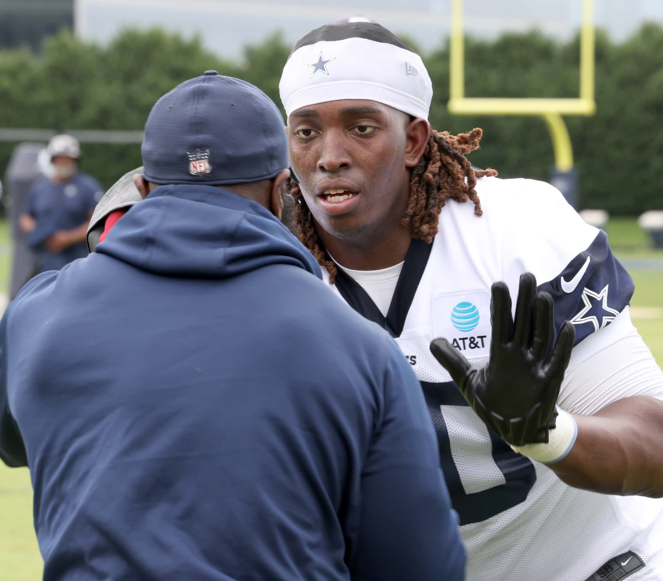 Dallas Cowboys offensive lineman Tyler Guyton (60) works on a hand-eye reaction drill with a...