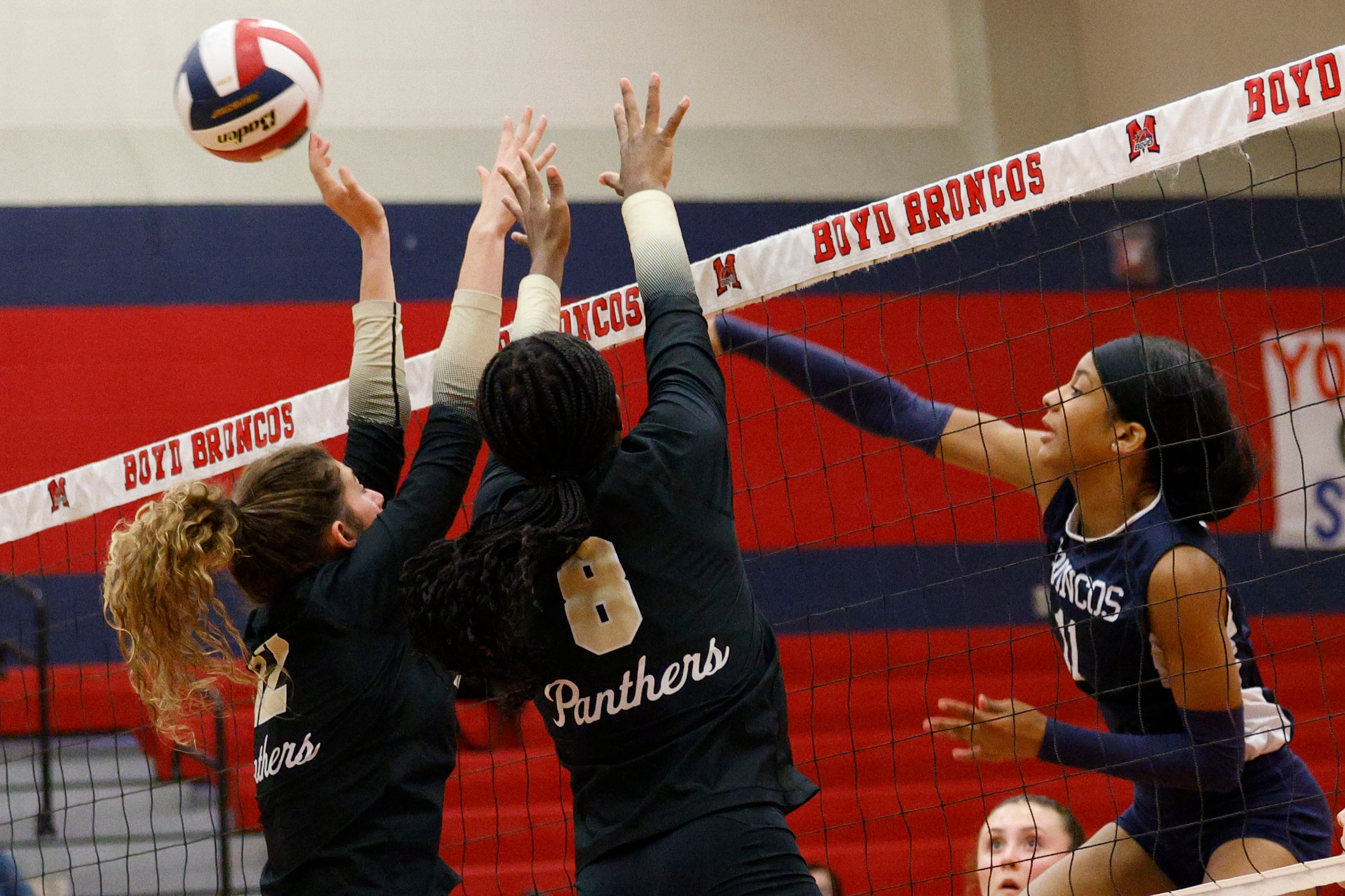 McKinney Boyd's Trinity Johnson (11) spikes the ball past Plano East's Grace McDonald (12)...