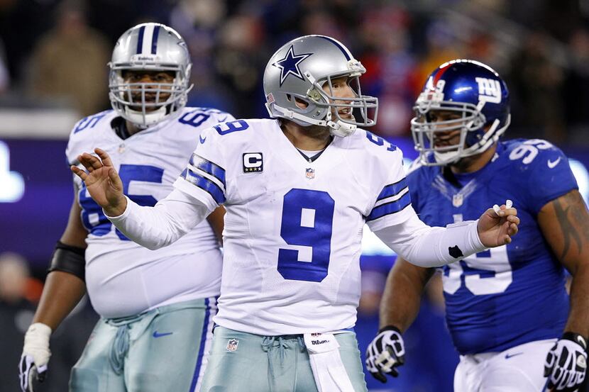 Dallas Cowboys quarterback Tony Romo (9) tries to hustle his players down the field on the...