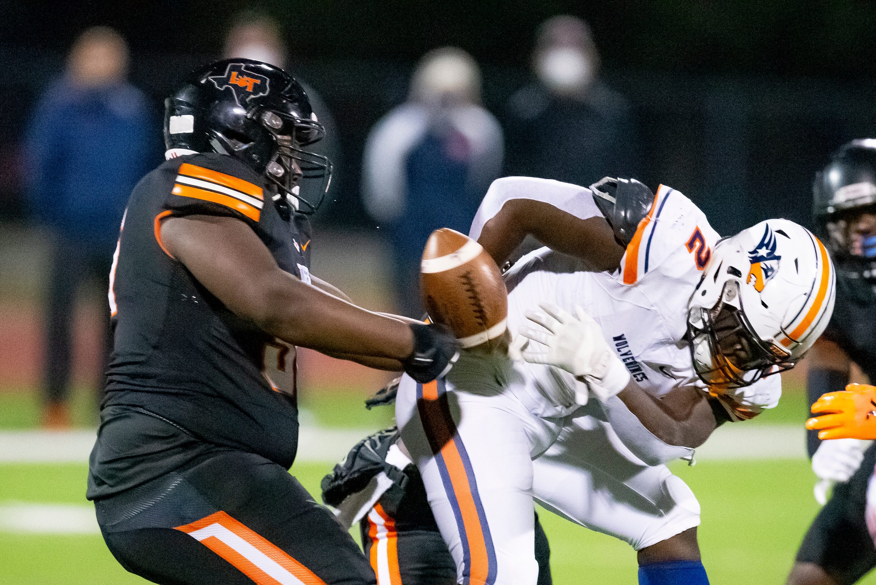 Lancaster junior defensive lineman Thomas Gort III (56) strips the ball from Wakeland junior...