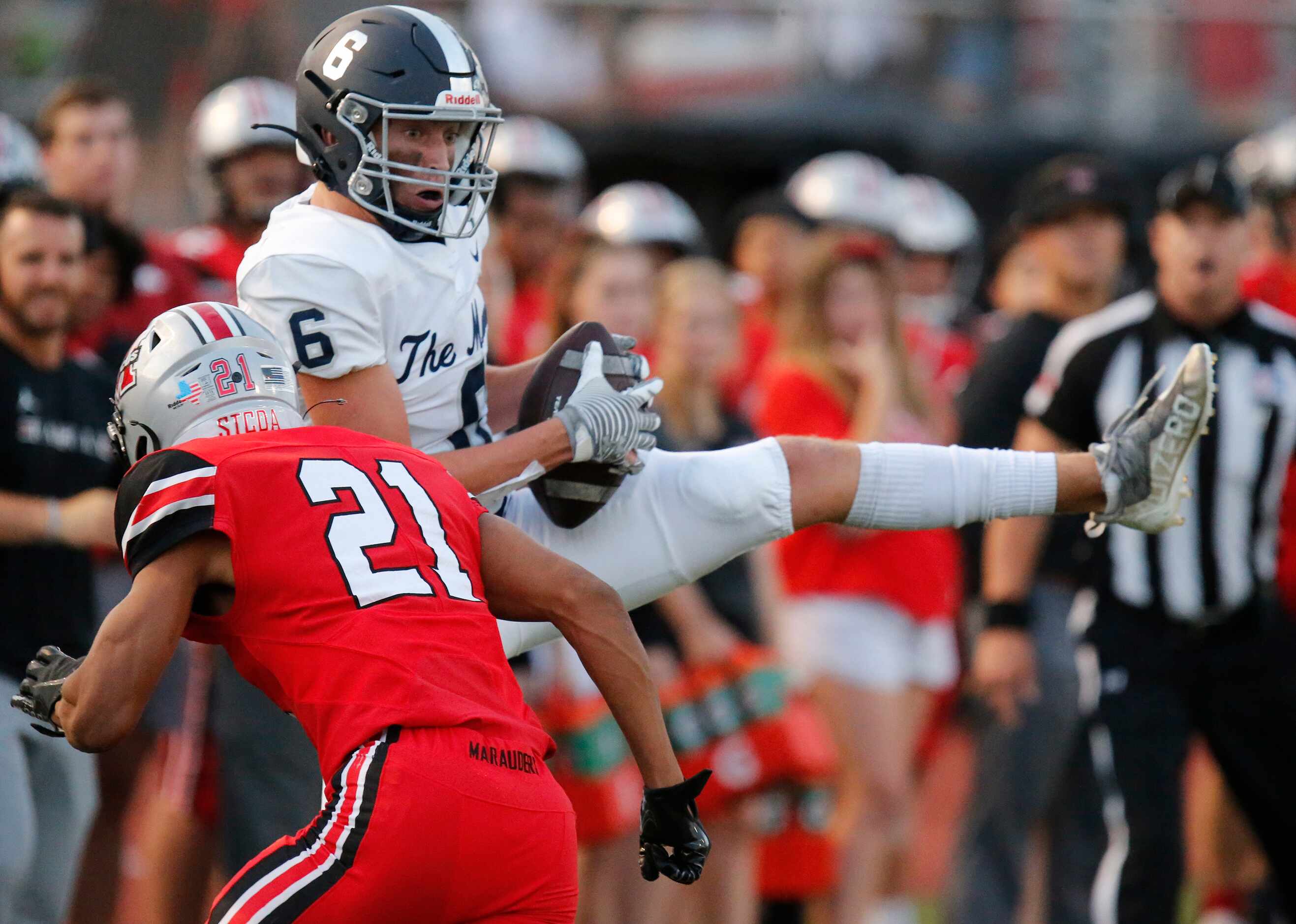 Flower Mound High School wide receiver Boston Lingenfelter (6) pulls in a pass in front of...