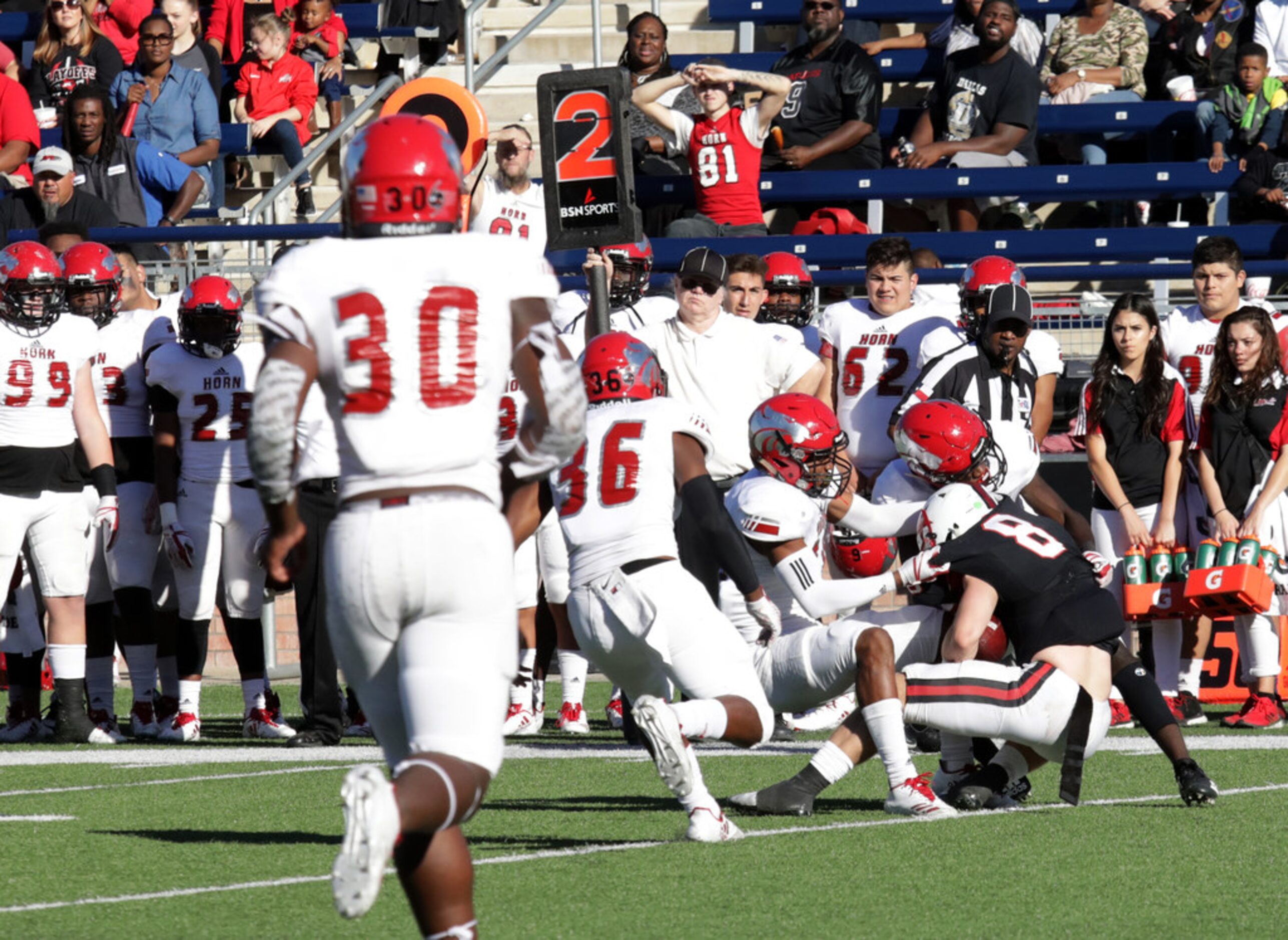 Coppell player 8, Blake Jackson, runs into a wall of Horn defensemen during a Class 6A...