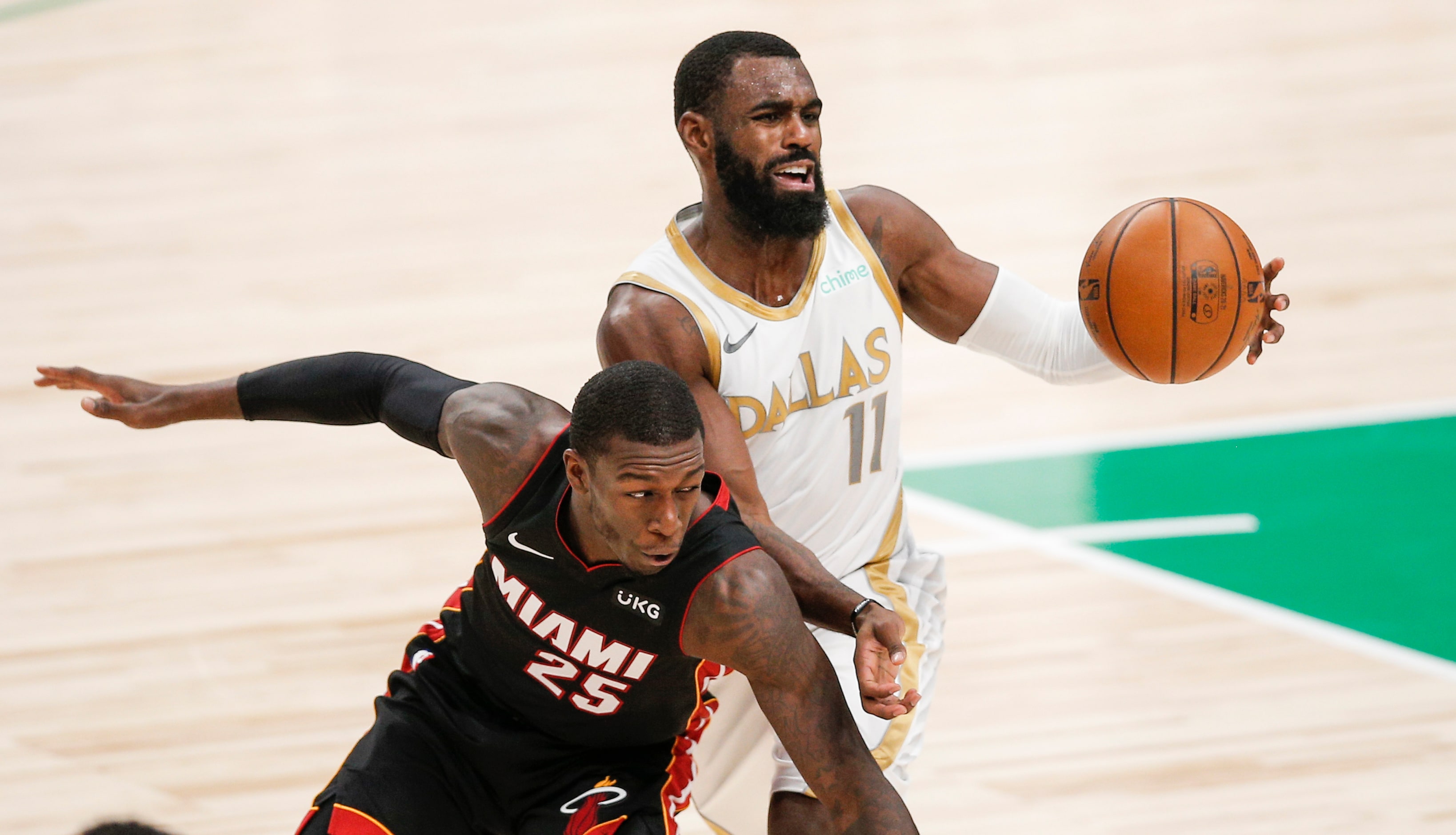 Dallas Mavericks guard Tim Hardaway Jr. (11) battles Miami Heat guard Kendrick Nunn (25) for...