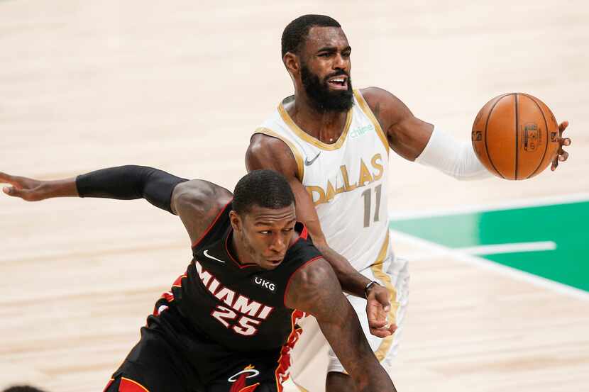 Dallas Mavericks guard Tim Hardaway Jr. (11) battles Miami Heat guard Kendrick Nunn (25) for...