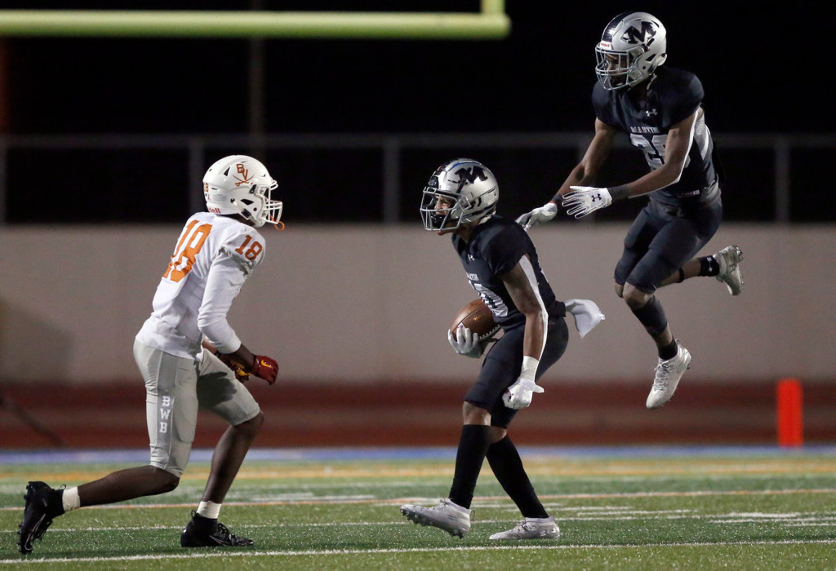 Martin defensive back Christian Traylor (10) is congratulated by Mickael Carodine (20) after...