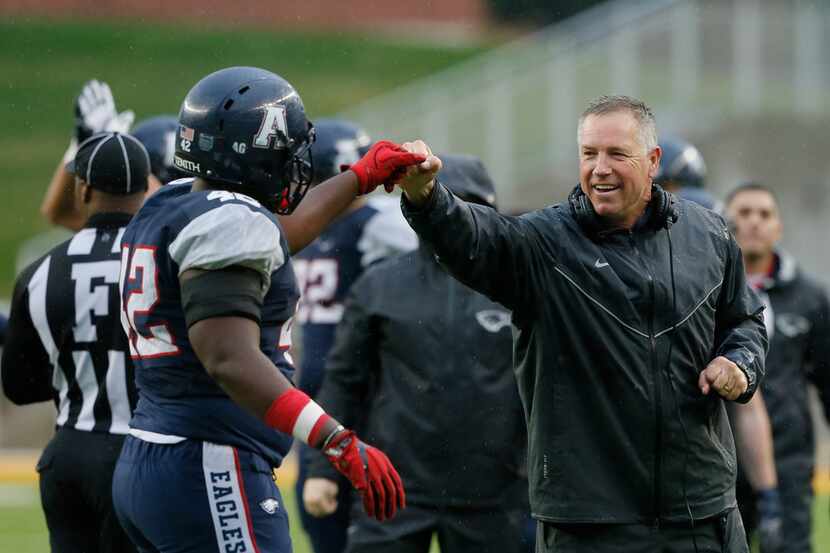 Allen football head coach Terry Gambill fist pumps with Jayden Jernigan (42) during the...