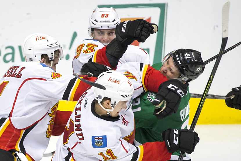 Dallas Stars left wing Antoine Roussel (21) tussles with Calgary Flames center Mikael...